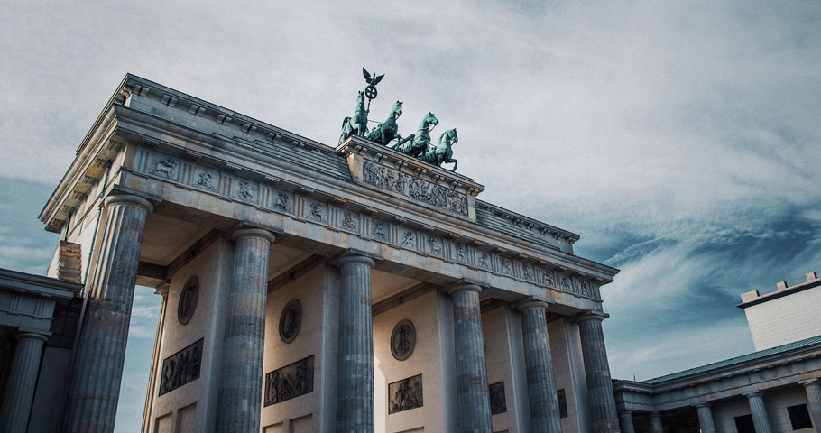View of Brandenburg Gate in Berlin. The sandstone structure consists of columns which form 5 passageways.