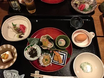 Multiple plates of Japanese food served on a tray