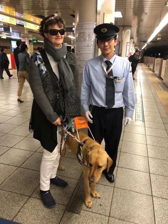 Nina and Nixon standing with the platform master