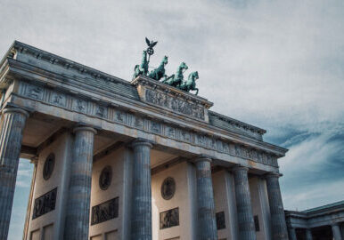 View of Brandenburg Gate, an 18th century monument located in Berlin. The sandstone structure consists of many columns which form 5 passageways.  